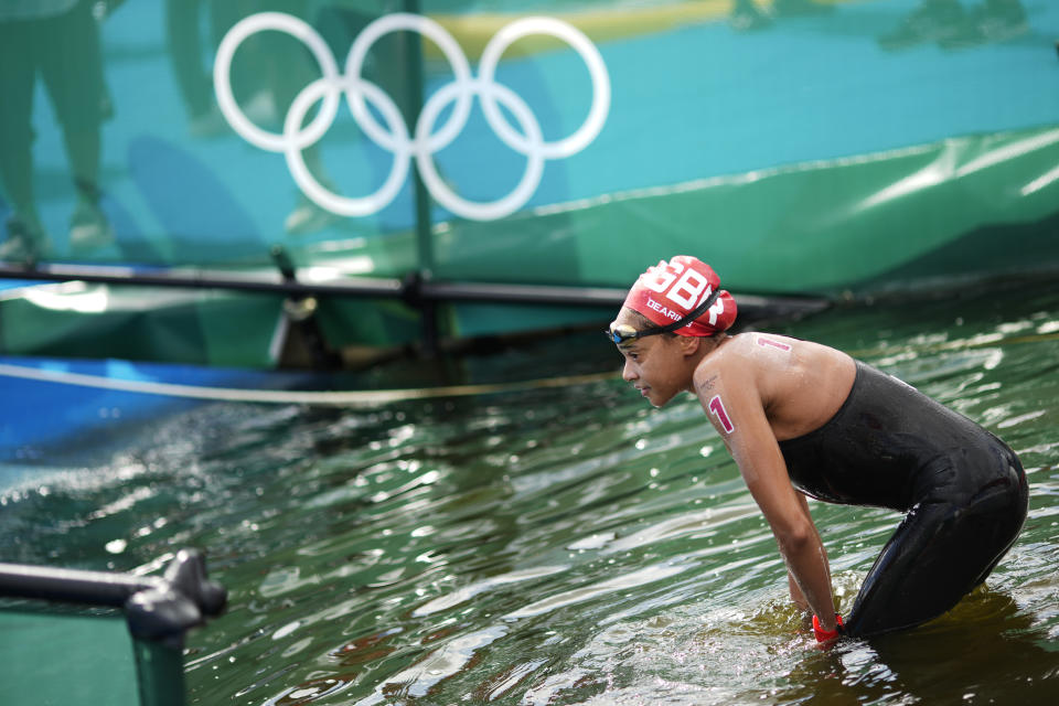 Alice Dearing, of Britain, exits the water after finishing the women's marathon swimming event at the 2020 Summer Olympics, Wednesday, Aug. 4, 2021, in Tokyo. (AP Photo/David Goldman)