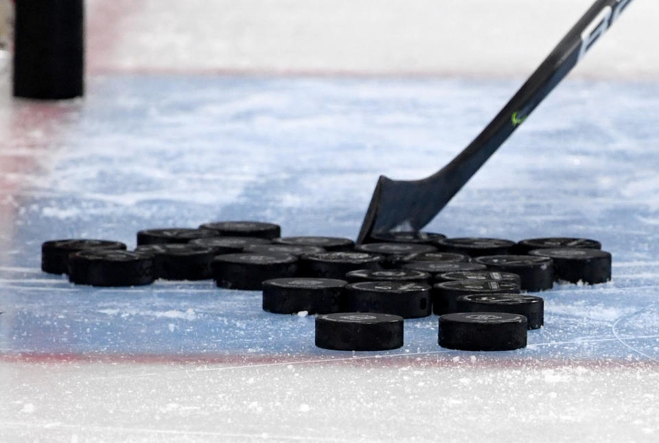 Hockey pucks with stick.