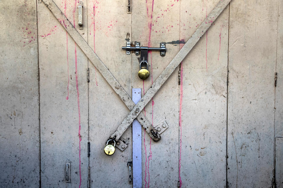 A shop is seen locked at a market area in Gauhati, India on June 18, 2021. Rows of locked shops confront bargain-hunters for most of the day in Fancy Bazar, a nearly 200-year-old market that offered cheap prices until the COVID-19 pandemic hit Gauhati, the biggest city in India’s remote northeast. (AP Photo/Anupam Nath)