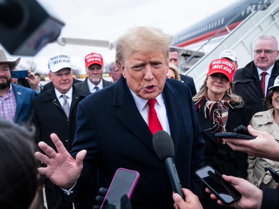 Former President Donald Trump speaks with reporters as he lands at Quad City International Airport en route to Iowa on Monday, March 13, 2023.