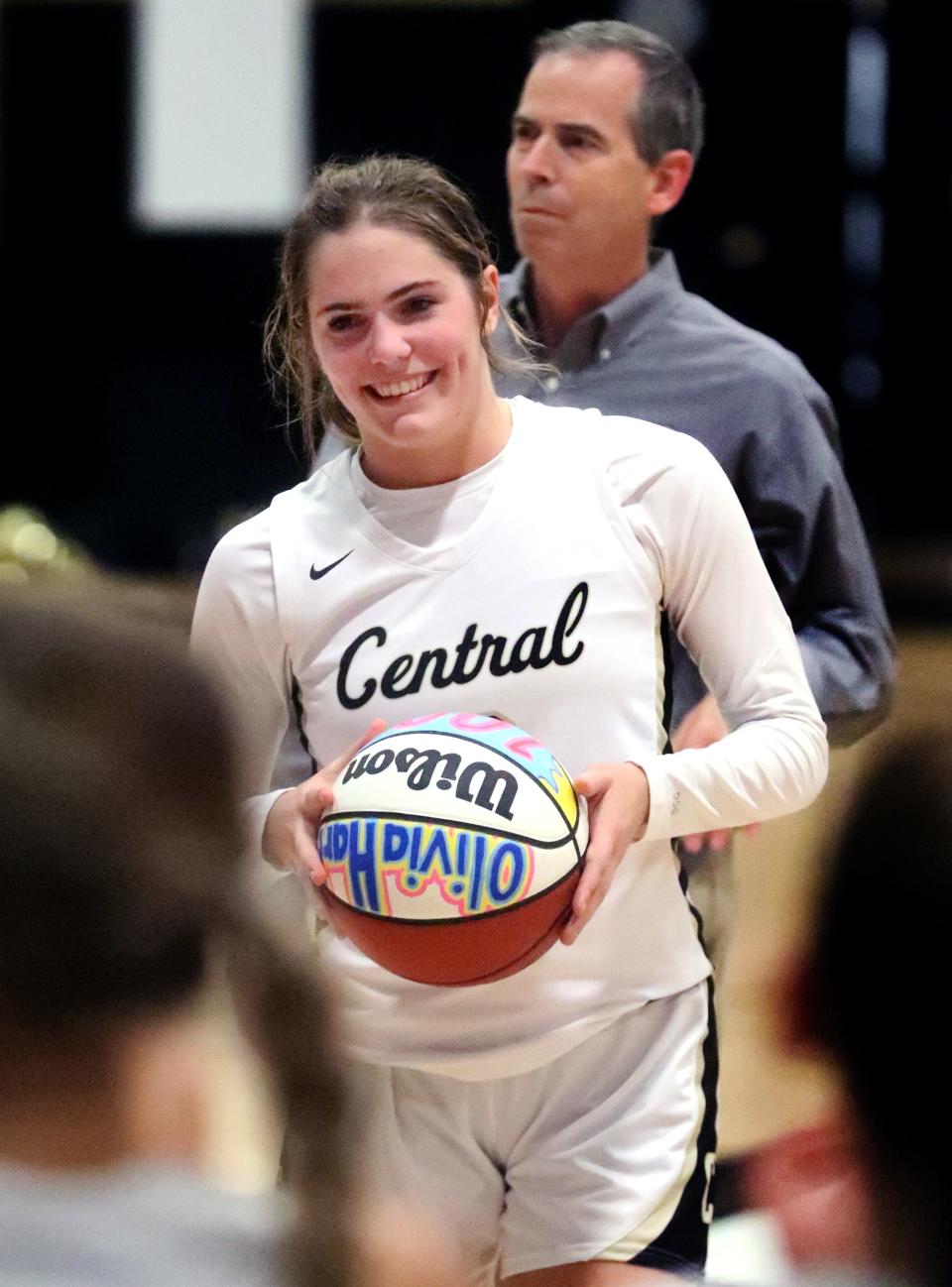 Central's Olivia Hart (2) celebrates receiving a ball for 1000 points scored in her career with her teammates. The ball was presented to her by Central's head coach Alan Bush on Monday, Nov. 21, 2022, between the girl's and boy's game. Central's Olivia Hart (2) reached the 1000 point during the game on Saturday, Nov. 19, 2022.