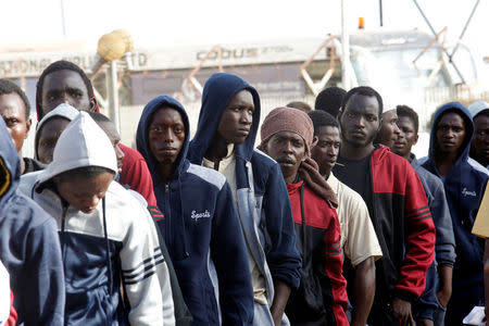 Gambian migrants who voluntarily returned from Libya stand in line as they wait to register at the airport in Banjul, Gambia April 4, 2017. REUTERS/Luc Gnago