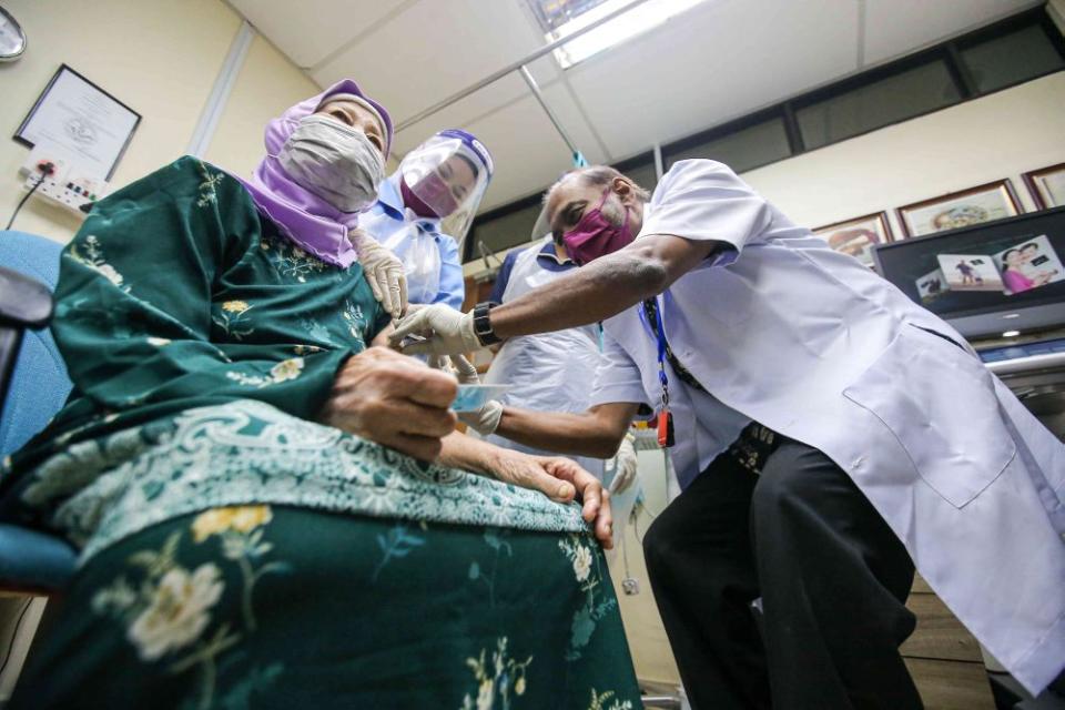 A senior citizen receives a dose of the Covid-19 vaccine at a clinic in Ipoh June 15, 2021. — Picture by Farhan Najib