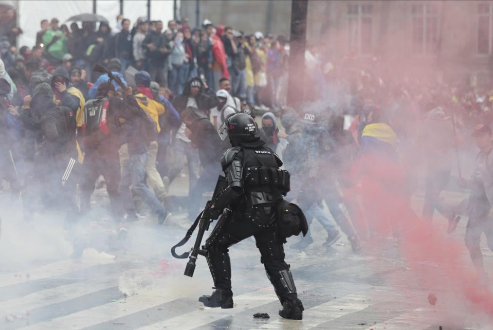 Police disperse anti-government protesters during a nationwide strike, at Bolivar square in downtown Bogota, Colombia, Thursday, Nov. 21, 2019. Colombia's main union groups and student activists called for a strike to protest the economic policies of Colombian President Ivan Duque government and a long list of grievances. (AP Photo/Fernando Vergara)