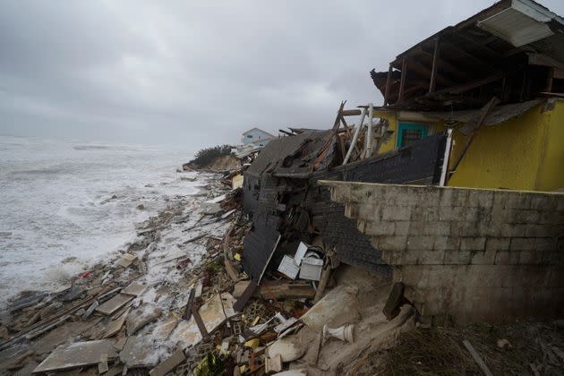 Parts of homes are seen collapsing on the beach due to the storm surge Thursday. (Photo: John Raoux via Associated Press)