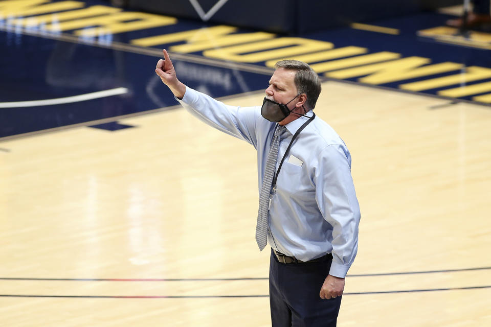 West Virginia coach Mike Carey gestures during the second half of the team's NCAA college basketball game against Baylor on Thursday, Dec. 10, 2020, in Morgantown, W.Va. (AP Photo/Kathleen Batten)