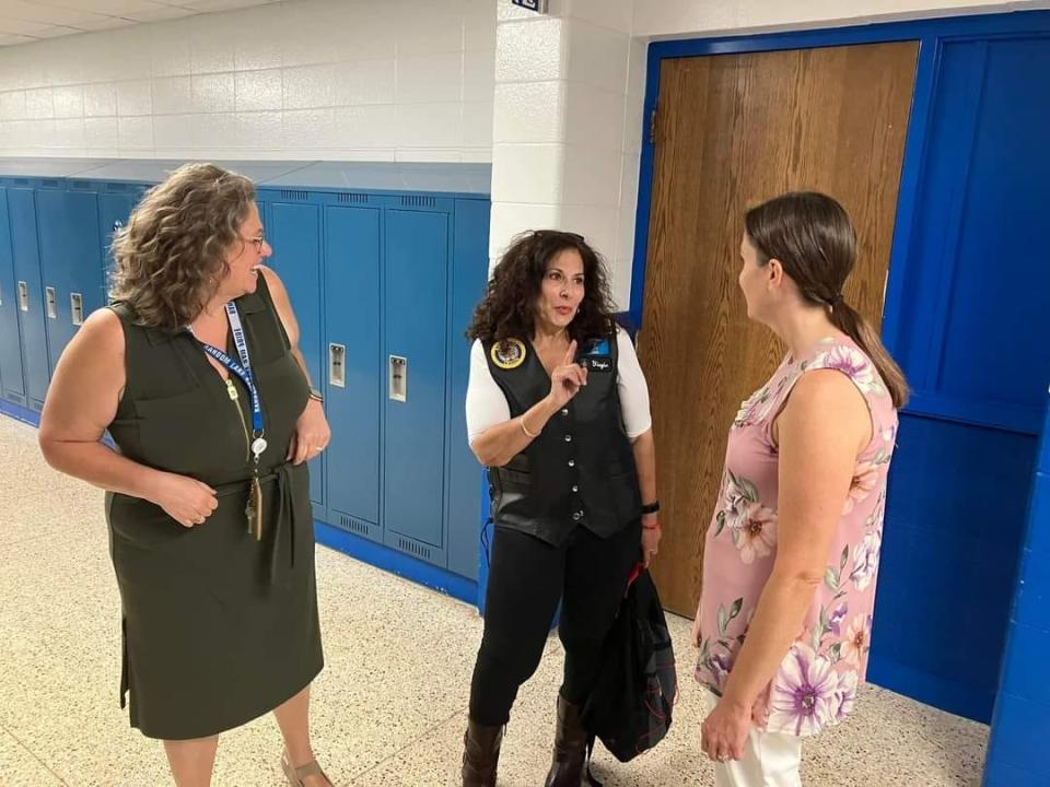 YiaYia Wischki (middle) speaks with Random Lake Middle School staff.