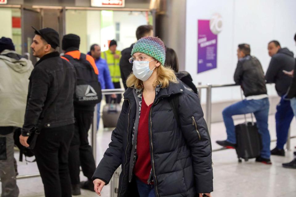 Passengers in the arrivals concourse at Heathrow Terminal 4 (PA)