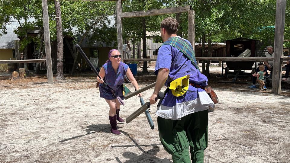 FILE - Gwen Schuckert, left, and Andrew Wade, right, fight with foam swords at EastWind Castle and Village in Trenton on April 29, 2023. EastWind will have a sword-fighting social on April 13.