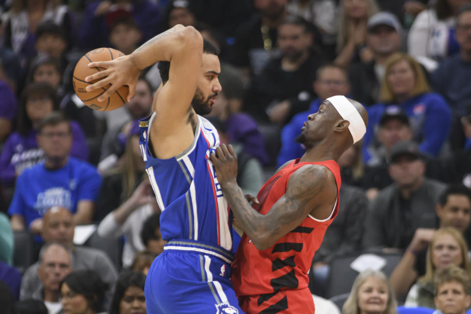 Sacramento Kings forward Trey Lyles, left, is guarded by Portland Trail Blazers Taze Moore during the first half of an NBA basketball game in Sacramento, Calif., Sunday, April 14, 2024. (AP Photo/Randall Benton)