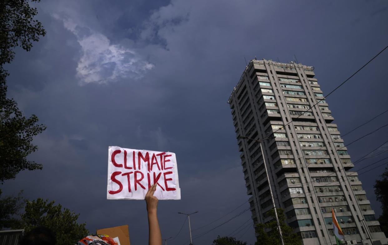 <span class="caption">A protestor holds a banner at the Fridays for Future march in New Delhi on Sept. 24, 2021. </span> <span class="attribution"><span class="source">(AP Photo/Manish Swarup) </span></span>