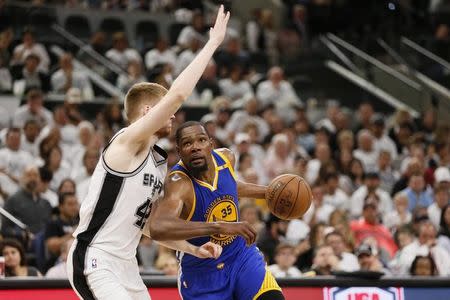 May 20, 2017; San Antonio, TX, USA; Golden State Warriors small forward Kevin Durant (35) drives to the basket while guarded by San Antonio Spurs small forward Davis Bertans (42) during the second half in game three of the Western conference finals of the NBA Playoffs at AT&T Center. Mandatory Credit: Soobum Im-USA TODAY Sports - RTX36S5K