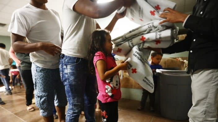 Central American migrants in an El Paso, Texas, shelter receive Red Cross blankets before sleeping on cots in May 2019. (Photo: Mario Tama/Getty Images)