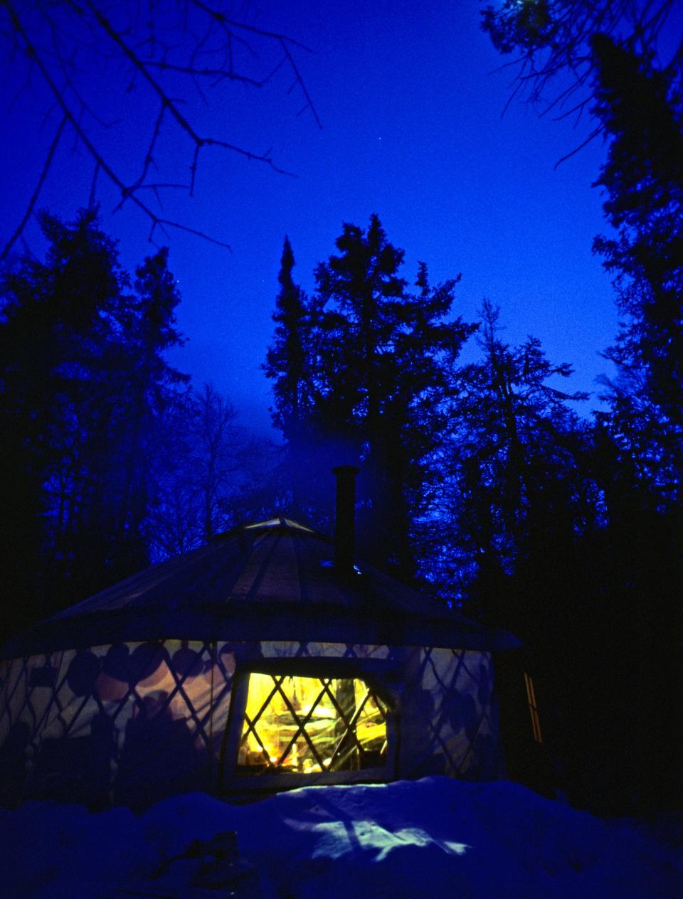 A yurt provides a cozy winter camp shelter and a view of a dazzling night sky on Minnesota’s Gunflint Trail.