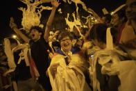 Catalan pro-independence demonstrators throw paper toilet rolls into the air during a protest in Barcelona Spain, Wednesday, Oct. 16, 2019. The Supreme Court found nine of 12 Catalan politicians and activists guilty of sedition and gave them prison sentences of nine to 13 years. Four of them were additionally convicted of misuse of public funds. The other three were fined for disobedience. (AP Photo/Bernat Armangue)
