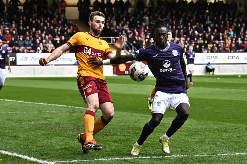 Motherwell's Stephen O'Donnell challenges Hibs' Elie Youan as the sides clashed at Fir Park in the Premiership