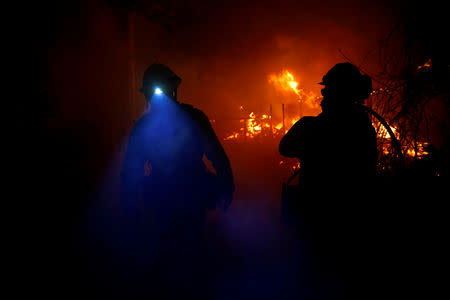 Firefighters battle the Woolsey Fire in Malibu, California, U.S. November 9, 2018. The fire destroyed dozens of structures, forced thousands of evacuations and closed a major freeway. REUTERS/Eric Thayer