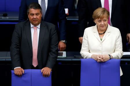 German Economy Minister Sigmar Gabriel (L) and Chancellor Angela Merkel attend a debate on the consequences of the Brexit vote at the lower house of parliament Bundestag in Berlin, Germany, June 28, 2016. REUTERS/Fabrizio Bensch