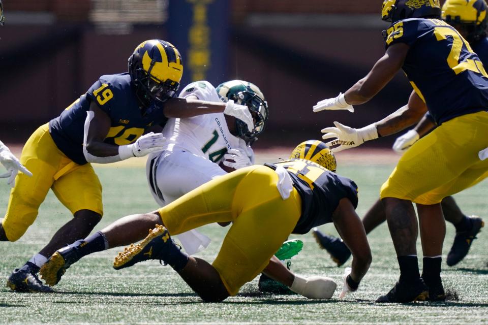 Colorado State wide receiver Tory Horton (14) is tackled by Michigan defensive back Rod Moore (19) and linebacker Taylor Upshaw during the first half of an NCAA college football game, Saturday, Sept. 3, 2022, in Ann Arbor, Mich. (AP Photo/Carlos Osorio)