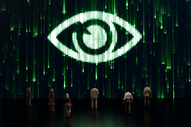 Businessman/politician figurines examine a matrix style eye. Artificial intelligence/technology/digital age concept (Photo: hamzaturkkol via Getty Images)