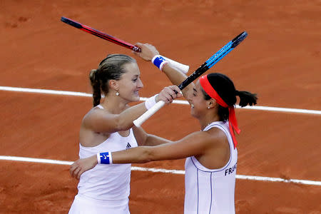 Tennis - Fed Cup - World Group Semi-Final - France v Romania - Kindarena, Rouen, France - April 21, 2019 France's Kristina Mladenovic and Caroline Garcia celebrate after winning their doubles match against Romania's Simona Halep and Monica Niculescu REUTERS/Charles Platiau