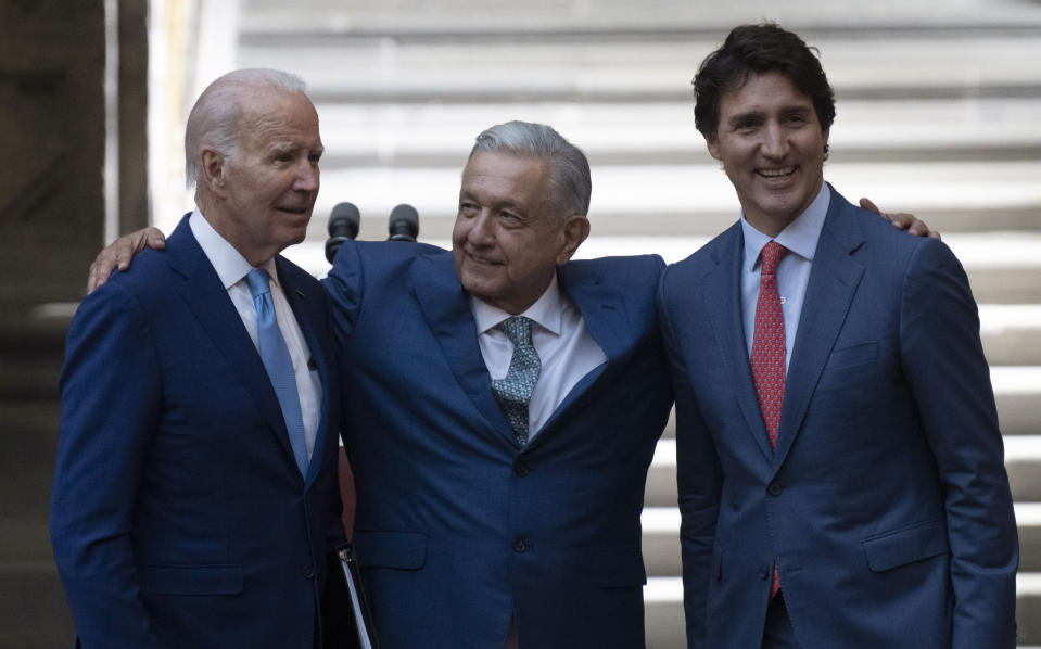 Mexican President Andres Manuel Lopez Obrador embraces, President Joe Biden and Canada Prime Minister Justin Trudeau following a joint news conference at the North American Leaders Summit, Tuesday, Jan. 10, 2023, in Mexico City. (Adrian Wyld/The Canadian Press via AP)