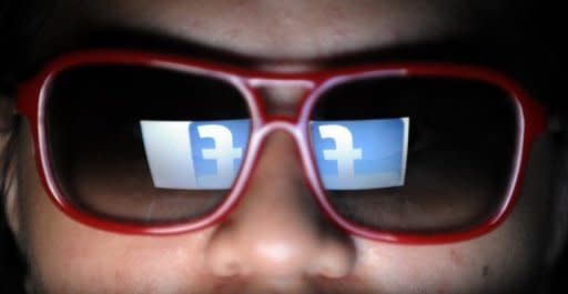 The Facebook logo is reflected on a man's sunglasses in Manila. The question of privacy and the use of personal data is a key issue for Facebook as the booming social network prepares to list on Wall Street