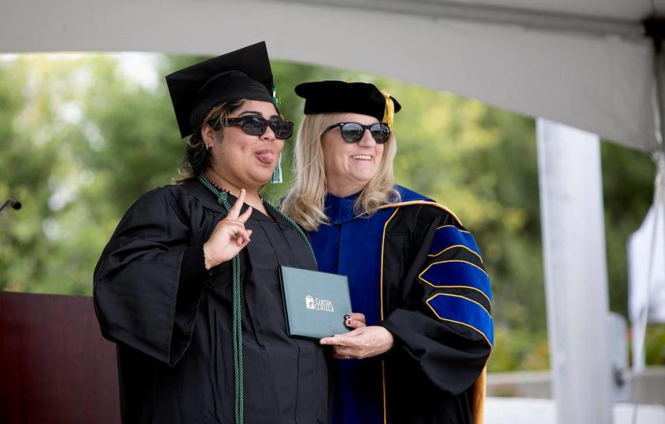 Cuesta College held its 59th commencement ceremony at the San Luis Obispo campus on Friday, May 17, 2024. Genesis Castillo sticks her tongue out next the Cuesta College superintendent Jill Stearns.