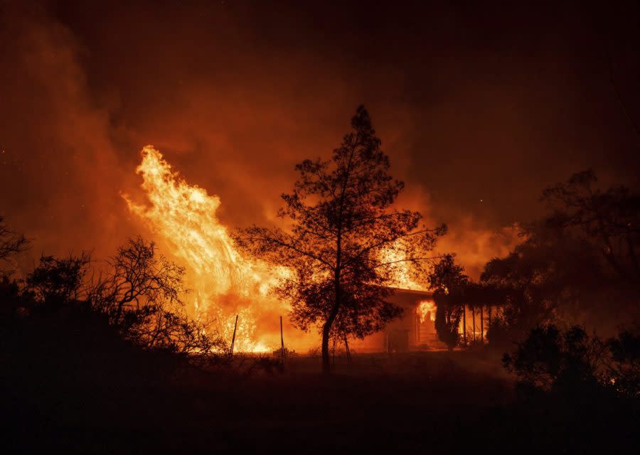 A structure is engulfed in flames as a wildfire called the Highland Fire burns in Aguanga, Calif., Oct. 30, 2023. (AP Photo/Ethan Swope, File)