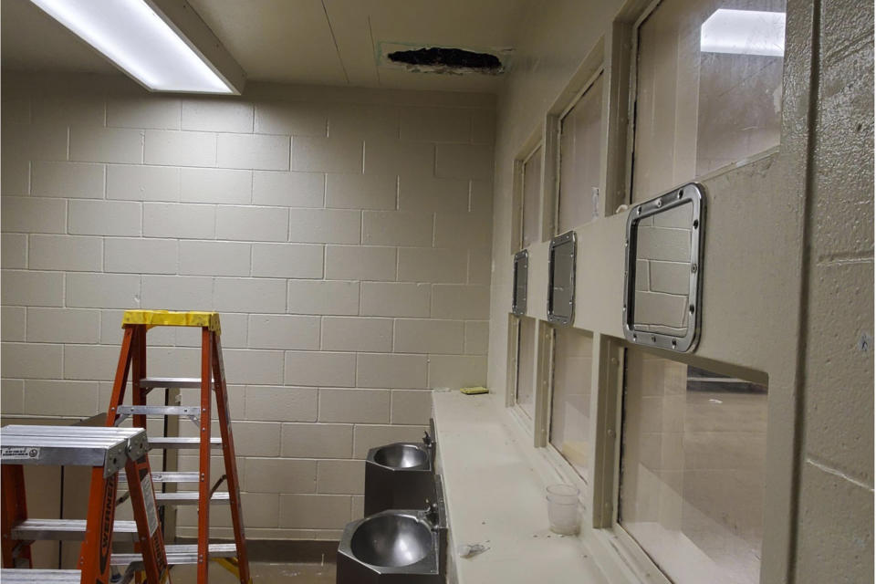 This photo provided Monday, Nov. 4, 2019, by the Monterey County Sheriff's Office shows a hole cut into the ceiling and the area that Santos Fonseca and Jonathan Salazar escaped from in the county jail in Salinas, Calif. The two murder suspects escaped the jail over the weekend after climbing through the hole they made in a bathroom ceiling in their housing unit and then working their way through a wall until they reached a hatch they kicked open to leave the building, an official said Monday, Nov. 4, 2019. (Monterey County Sheriff's Office via AP)