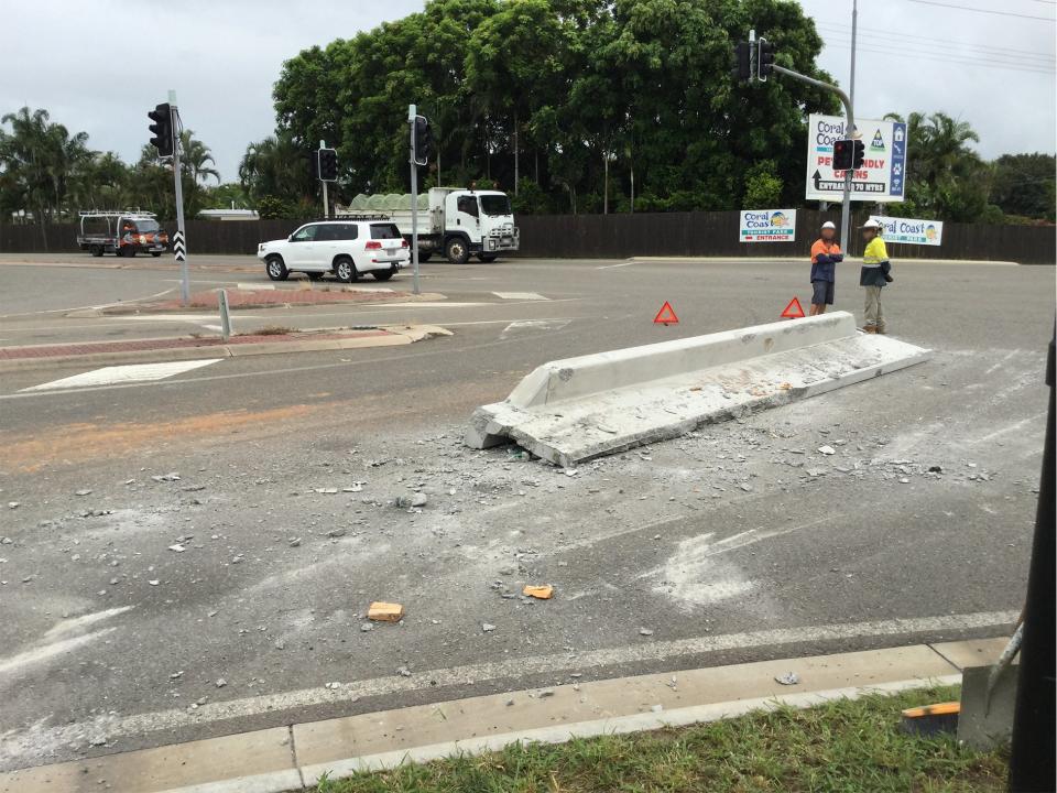 A concrete barrier sits on the road after falling off a truck in Townsville.