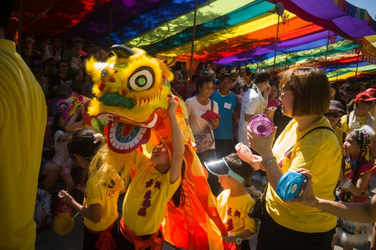 Visitors watch as performers take part in the annual Cheung Chau bun festival parade