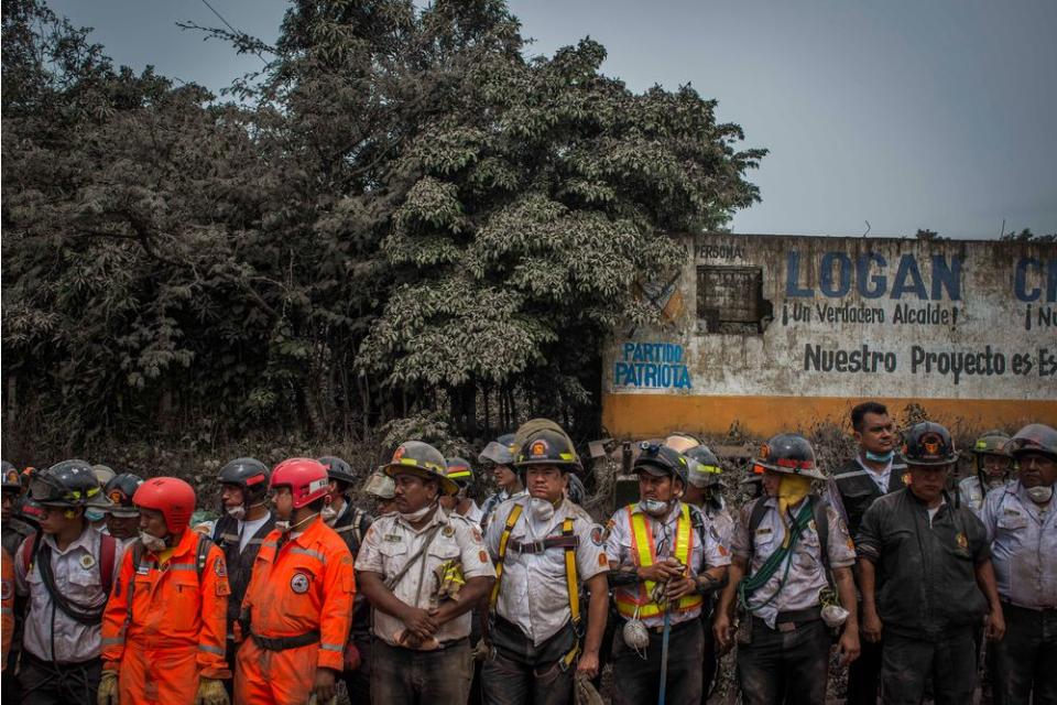 Rescue workers in between search missions in San Miguel Los Lotes on June 4.