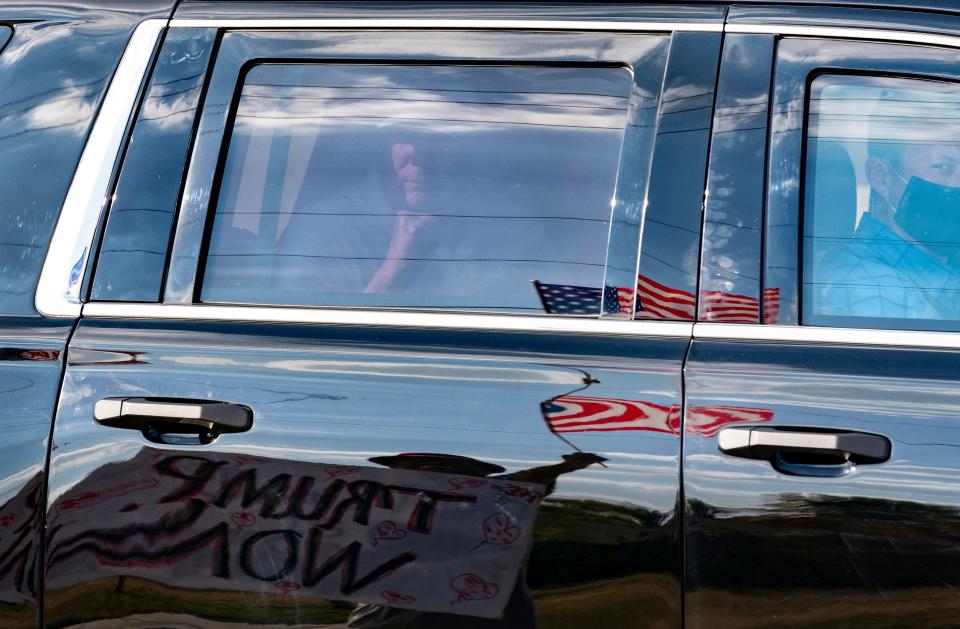 President Donald Trump passes supporters while traveling in his motorcade in West Palm Beach, Fla., on Wednesday, January 27, 2021 on his way to Mar-a-Lago in Palm Beach.  