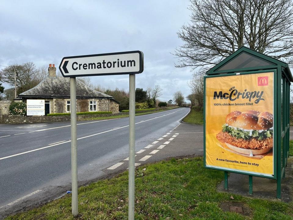 A photo showing the McDonald's ad with the crematorium in the background