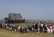 Crowds watch the final spring of United States' Collin Morikawa and South Africa's Louis Oosthuizen play the 7th hole during the final round of the British Open Golf Championship at Royal St George's golf course Sandwich, England, Sunday, July 18, 2021. (AP Photo/Peter Morrison)