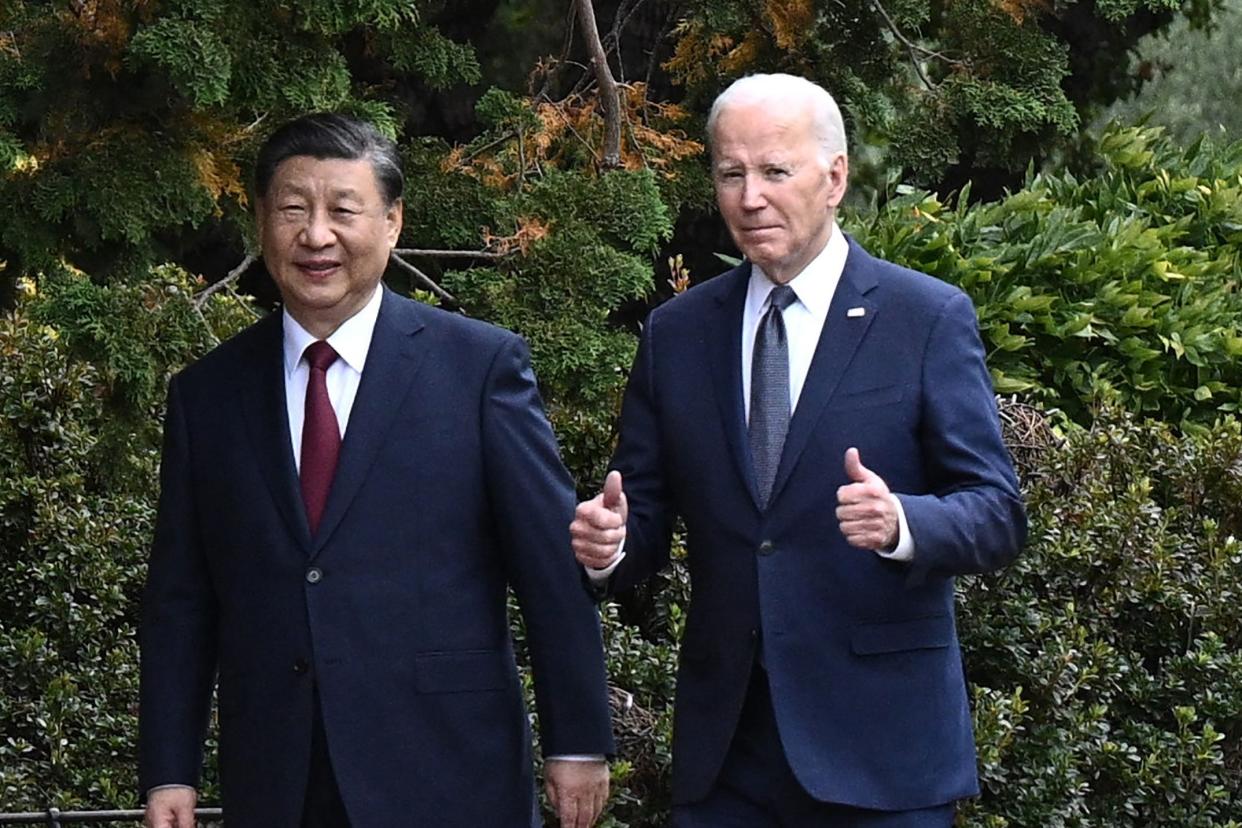 US President Joe Biden (R) and Chinese President Xi Jinping walk together after a meeting during the Asia-Pacific Economic Cooperation (APEC) Leaders' week in Woodside, California on November 15, 2023.