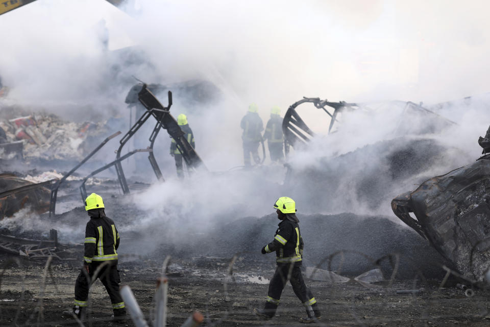 Firefighters work to extinguish a burning fuel tanker in Kabul, Afghanistan, Sunday, May 2, 2021. A fire roared through several fuel tankers on the northern edge of the Afghan capital late Saturday, injuring at least 10 people and plunging much of the city into darkness, officials said. (AP Photo/Rahmat Gul)