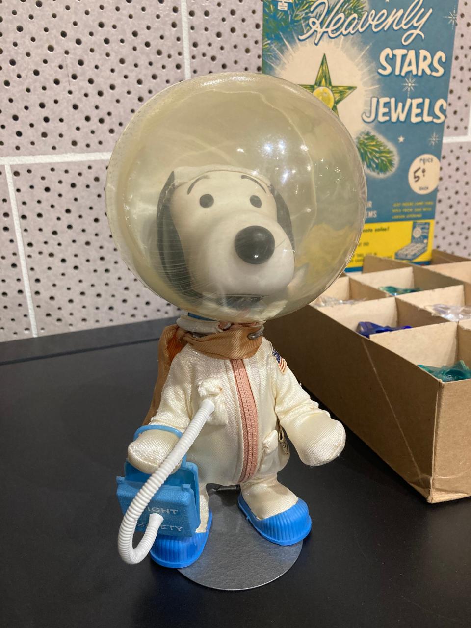 A Snoopy the Astronaut doll is among the items included in the new Keller Gallery exhibition, "A Constellation of Objects." Organizers paired everyday items in a display that highlights the night sky.