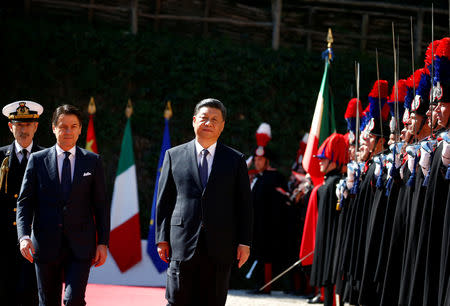 Chinese President Xi Jinping and Italian Prime Minister Giuseppe Conte inspect the honor guard during a welcoming ceremony at Villa Madama in Rome, Italy March 23, 2019. REUTERS/Yara Nardi