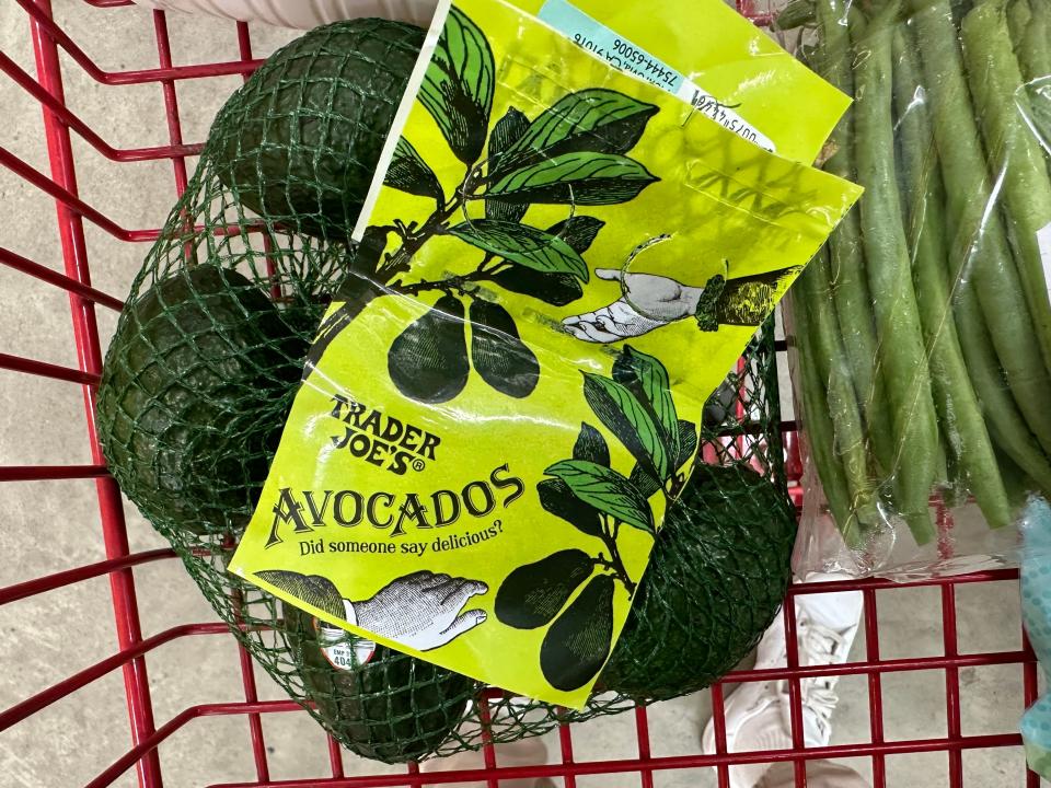 bag of trader joe's teeny tiny avocados in a red shopping cart