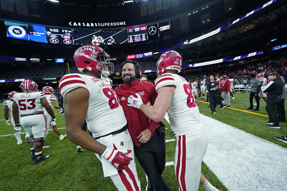 Louisiana-Lafayette head coach Michael Desormeaux celebrates with tight ends Johnny Lumpkin (88) and Hunter Bergeron in the second half of the New Orleans Bowl NCAA football game against Marshall in New Orleans, Saturday, Dec. 18, 2021. Louisiana-Lafayette won 36-21. (AP Photo/Gerald Herbert)