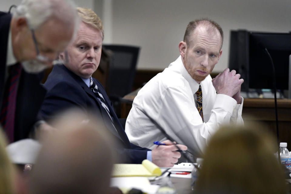 FILE - In this Wednesday, Aug. 4, 2021, file photo, Chad Isaak, right, of Washburn, sits with his defense team during the third day of his murder trial at the Morton County Courthouse in Mandan, N.D. Jurors returned guilty verdicts Friday, Aug. 20, 2021 on all counts against Isaak, who was charged in the deaths of RJR Maintenance & Management co-owner Robert Fakler and employees Adam Fuehrer, William Cobb and Lois Cobb in April 2019. (Mike McCleary/The Bismarck Tribune via AP)