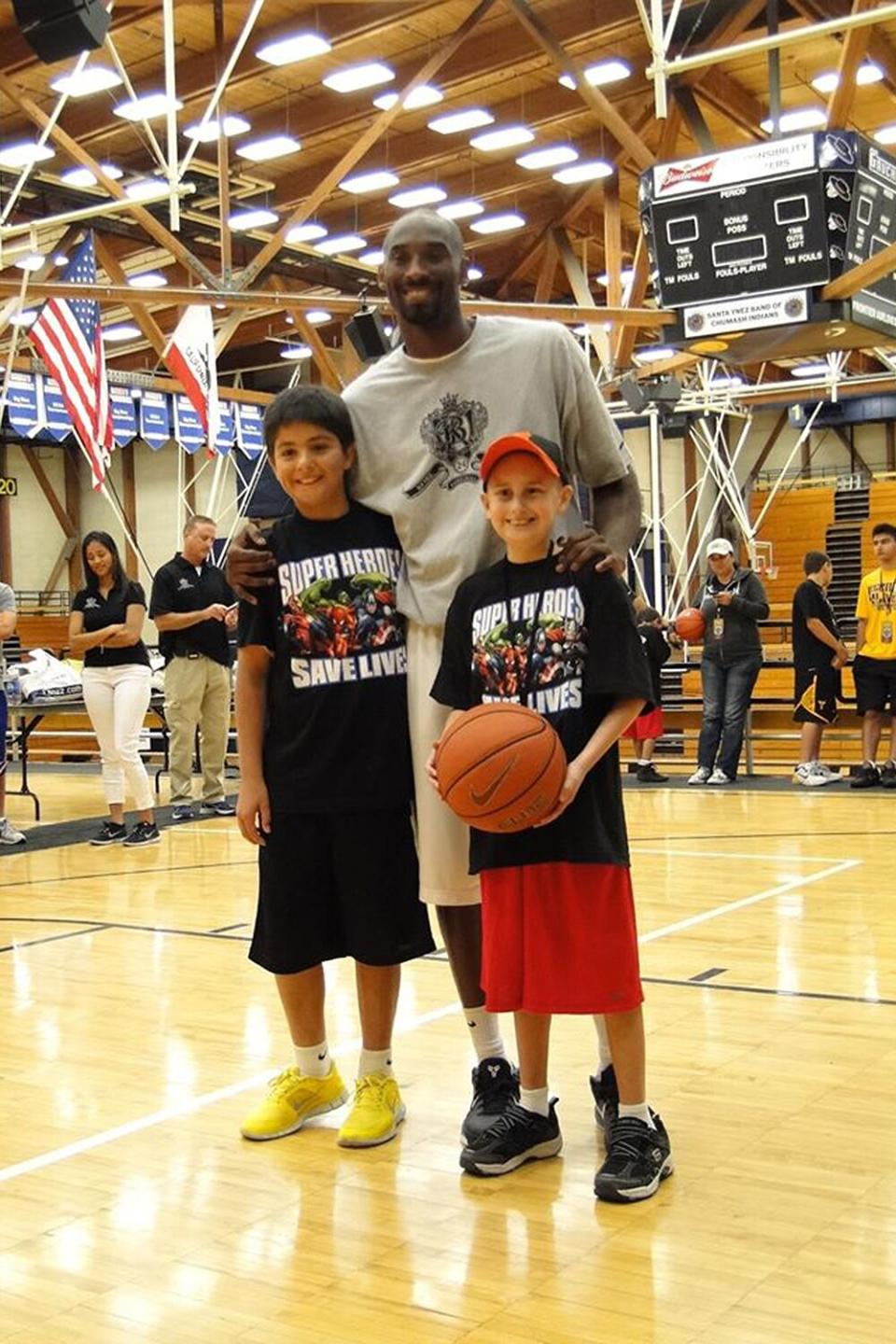 Through Stand Up to Cancer, Bryant helped raise more than $81 million for cancer research in 2012. He also posted a <a href="https://www.facebook.com/Kobe/photos/a.115811505418/10151013483865419/?type=3&theater" rel="nofollow noopener" target="_blank" data-ylk="slk:photo;elm:context_link;itc:0;sec:content-canvas" class="link ">photo</a> on Facebook of two kids he met through the program, writing, "We have to <a href="https://www.facebook.com/SU2C/?__tn__=%2CdK%2AF-R&eid=ARCVxBFZDHH_v9ZIwxI5-PnsSX5EOqXBIKeWBR3-rydZlO4r4IDfEr_Xng9z8rp-_-1KKMIDDnTsmhdy" rel="nofollow noopener" target="_blank" data-ylk="slk:Stand Up To Cancer;elm:context_link;itc:0;sec:content-canvas" class="link ">Stand Up To Cancer</a>! Kid's shouldn't have to suffer. I met the most amazing kids today at camp."