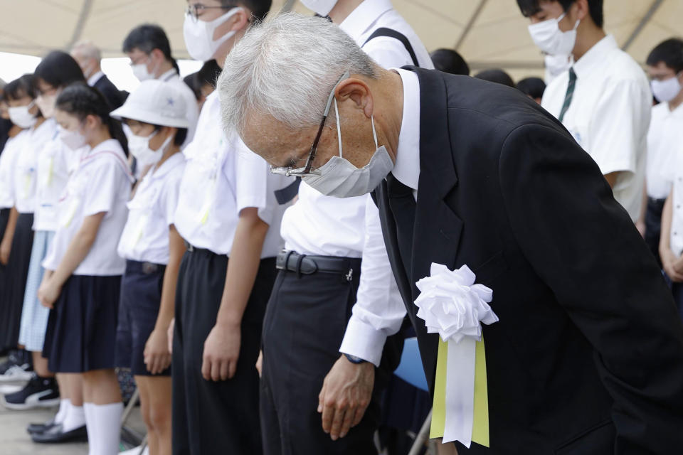 People offer silent prayers during a ceremony to mark the 77th anniversary of the U.S. atomic bombing in Nagasaki, southern Japan, Tuesday, Aug. 9, 2022. (Kyodo News via AP)