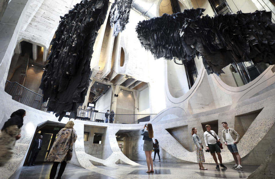 An installation by Malagasy artist Joel Andrianomearisoa "The Five Continents of All Our Desires," is seen in the Zeitz Museum of Contemporary Art Africa in Cape Town, South Africa, Wednesday, Sept. 7, 2022. The work transforms the towering atrium of the museum with black silk paper suspended in the museum's multi-story central atrium.(AP Photo/Nardus Engelbrecht)