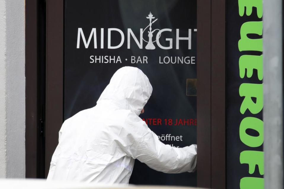 Police investigators enter the Midnight shisha bar after two shootings in Hanau, Germany.