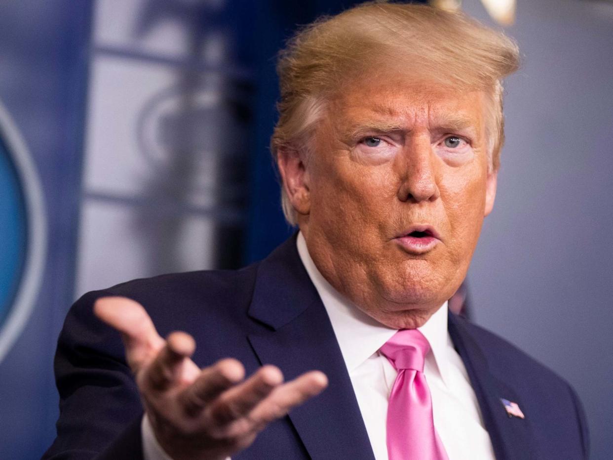 President Donald Trump with members of the president's coronavirus task force speaks during a news conference: AP