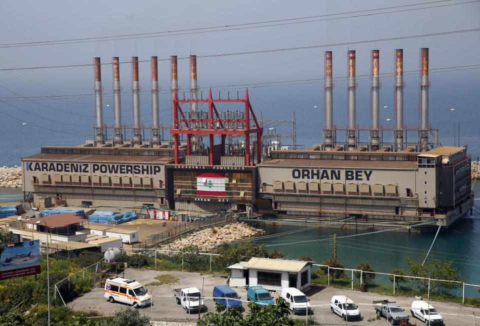 File - In this April 8, 2019, file photo, the Turkish floating power station Karadeniz Powership Orhan Bey, which generates electricity to help ease the strain on the country's woefully under-maintained power sector, is docked near the Jiyeh power plant, south of Beirut, Lebanon. The company Karpowership that operates the facility said Friday it has shut down it has suspended its operations, a move expected to increase outages in the crisis-hit Mediterranean country. (AP Photo/Hussein Malla, File)