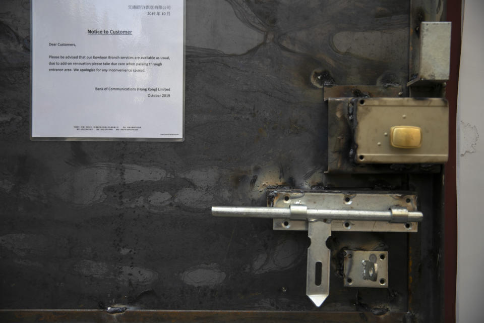 Locks and deadbolts are seen on the inside of a metal door that has been installed on the exterior of a Bank of Communications branch in Hong Kong, Friday, Oct. 25, 2019. Banks, retailers, restaurants and travel agents in Hong Kong with ties to mainland China or perceived pro-Beijing ownership have fortified their facades over apparent concern about further damage after protesters trashed numerous businesses following a recent pro-democracy rally. (AP Photo/Mark Schiefelbein)